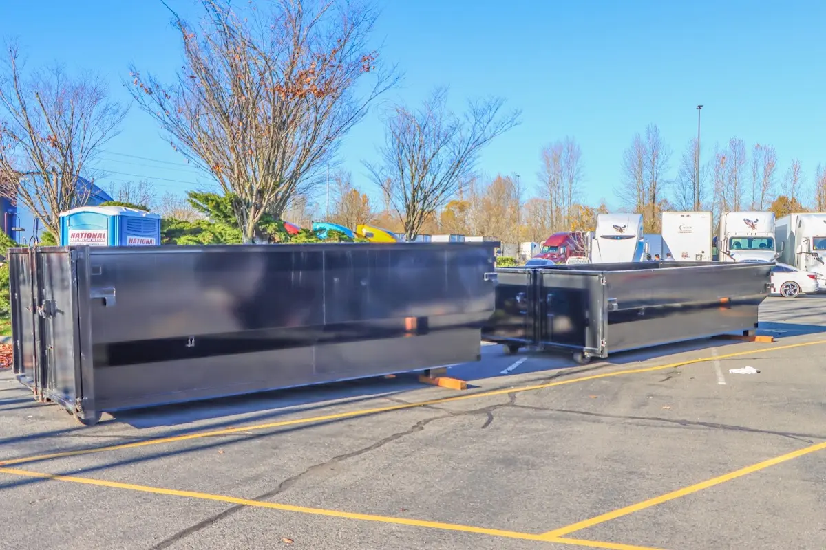 Professional dumpster rental service with roll-off container on residential driveway in Wilmette